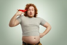 funny-overweight-fat-man-with-curly-ginger-hair-holding-big-chile-pepper-his-temple-like-pistol_273609-9572.jpeg
