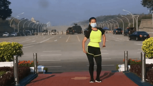 Myanmar Aerobic Instructor Performs her Workout Routine with a Coup Behind Her